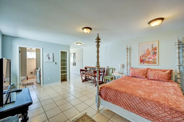 a bedroom with furniture and a window