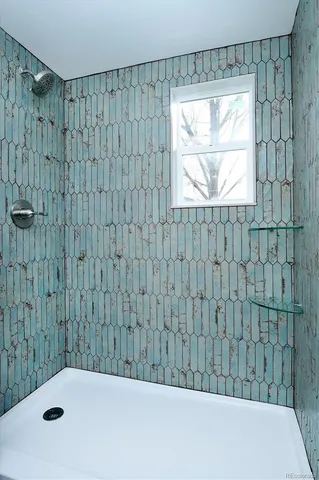 an empty room with wooden floor and ceiling fan