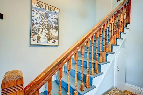a view of a hallway with wooden floor and entryway
