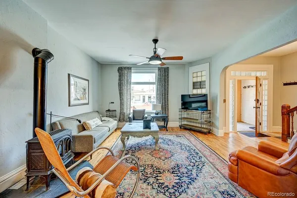 a living room with furniture and wooden floor