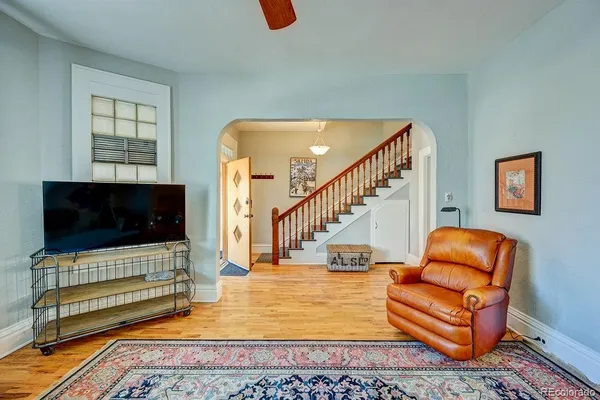 a dining room with furniture and wooden floor
