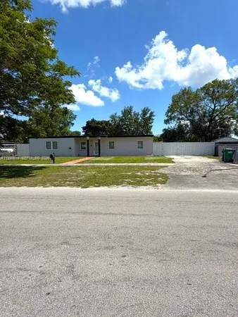 a view of a house and a yard