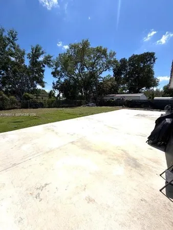 a kitchen with granite countertop a refrigerator and a stove top oven