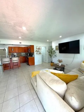 a living room with furniture and a baby crib