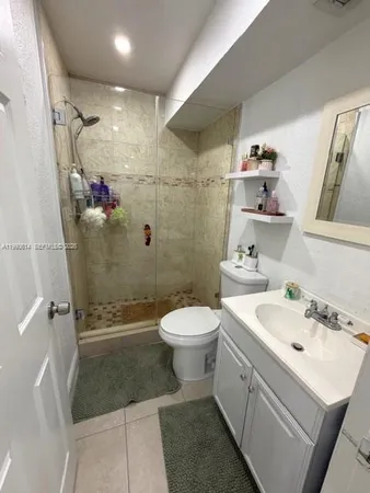 a bed sitting in a bedroom next to a cabinet