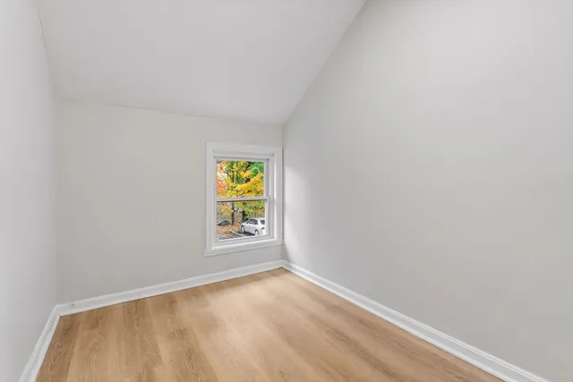 a view of an empty room and a window