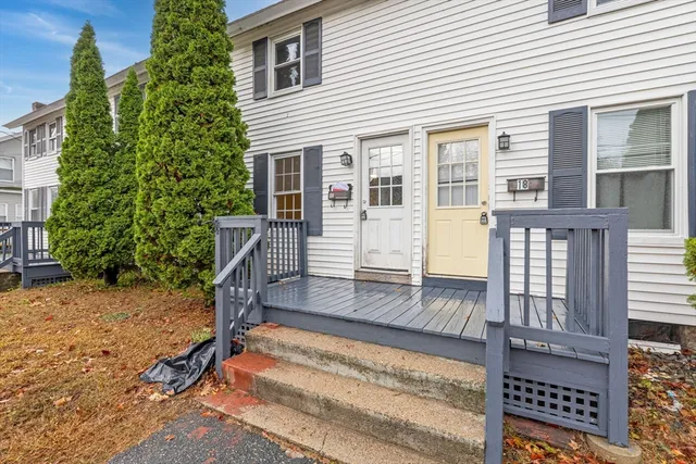 a view of house with wooden stairs and floor to ceiling window