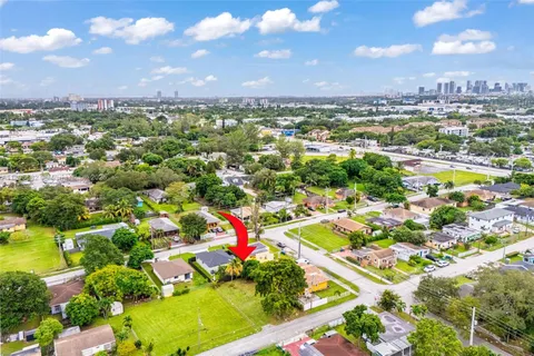 an aerial view of residential houses with outdoor space and swimming pool