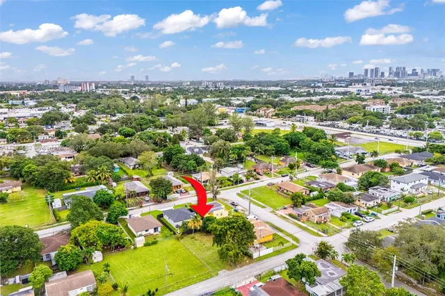 an aerial view of residential houses with outdoor space and swimming pool