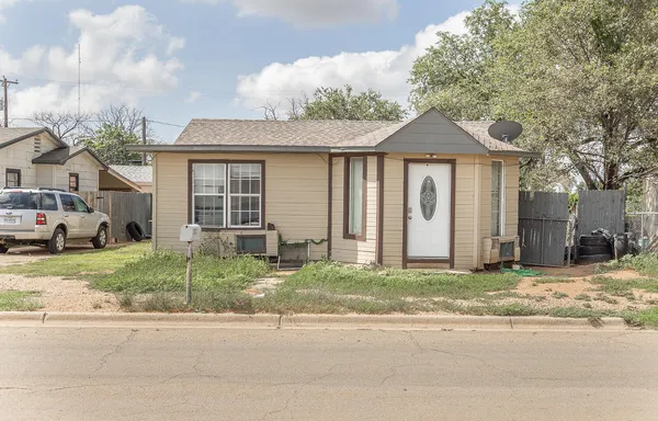 a house that has a large tree in front of it