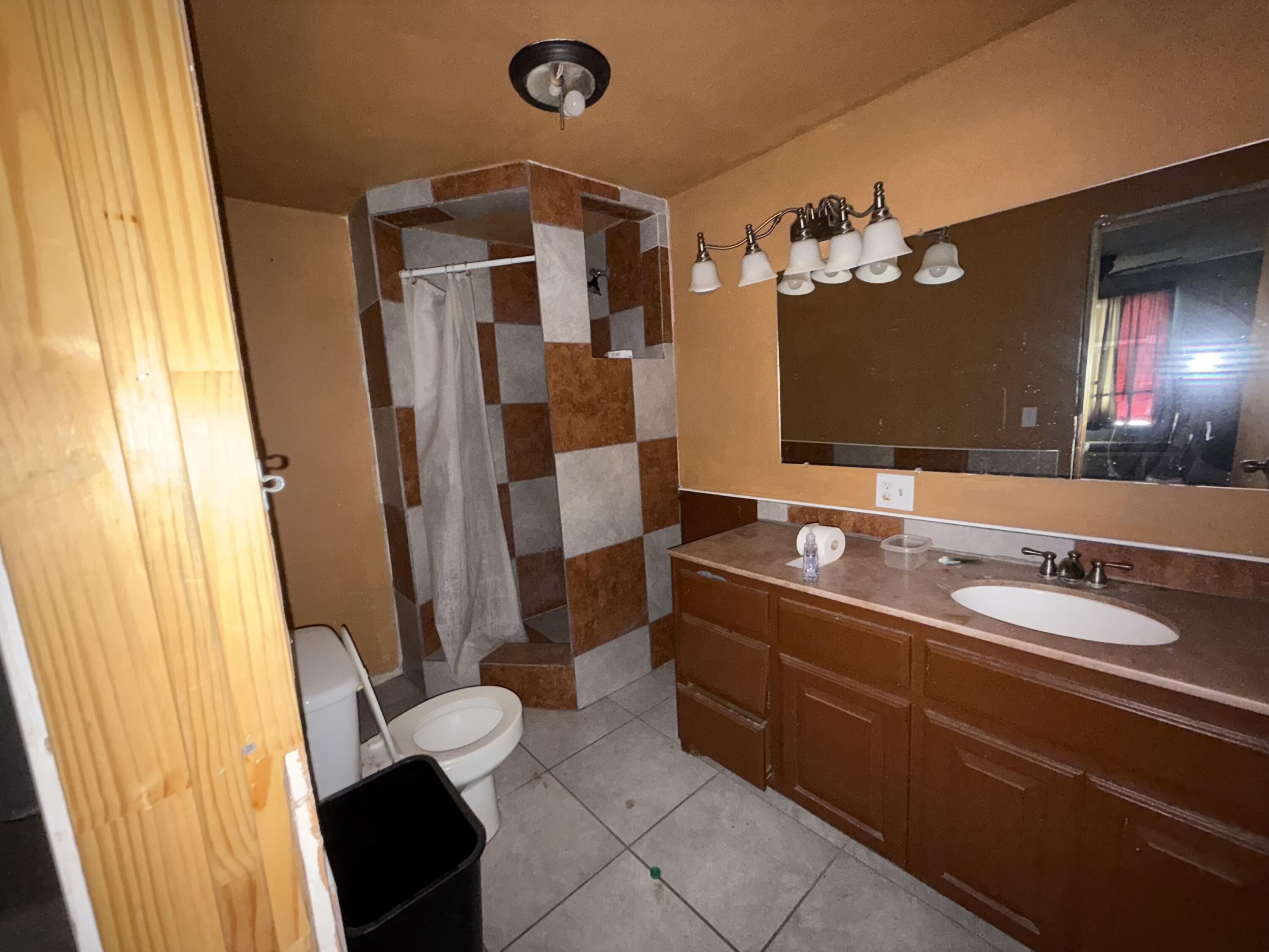 521 46th Street Lubbock, TX 79404 - Photo 6 of 10 a bathroom with a double vanity sink and mirror