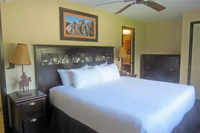 a large bed in a bedroom next to a window