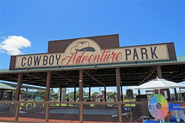 a view of a house with a yard and a fountain