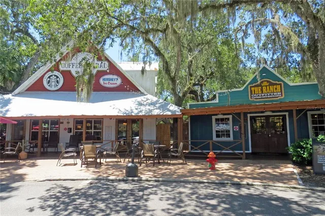 a backyard of a house with lots of green space and lake view