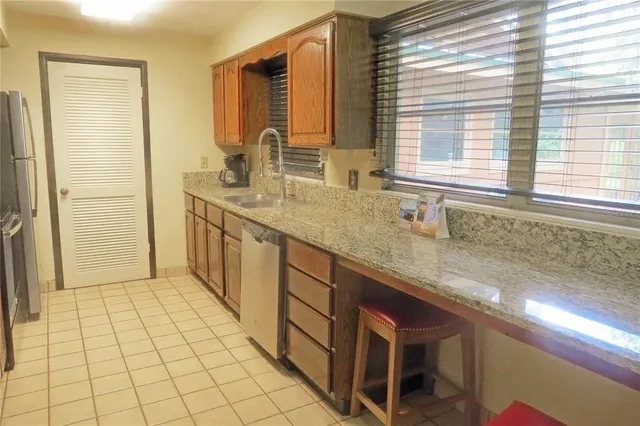 a spacious bathroom with a granite countertop sink a mirror and a shower