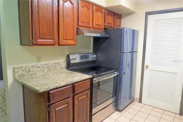 a kitchen with stainless steel appliances granite countertop a refrigerator sink and cabinets