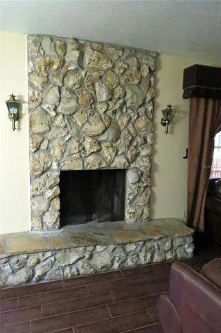 a living room with a fireplace and a flat screen tv