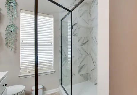 a bathroom with a shower and toilet