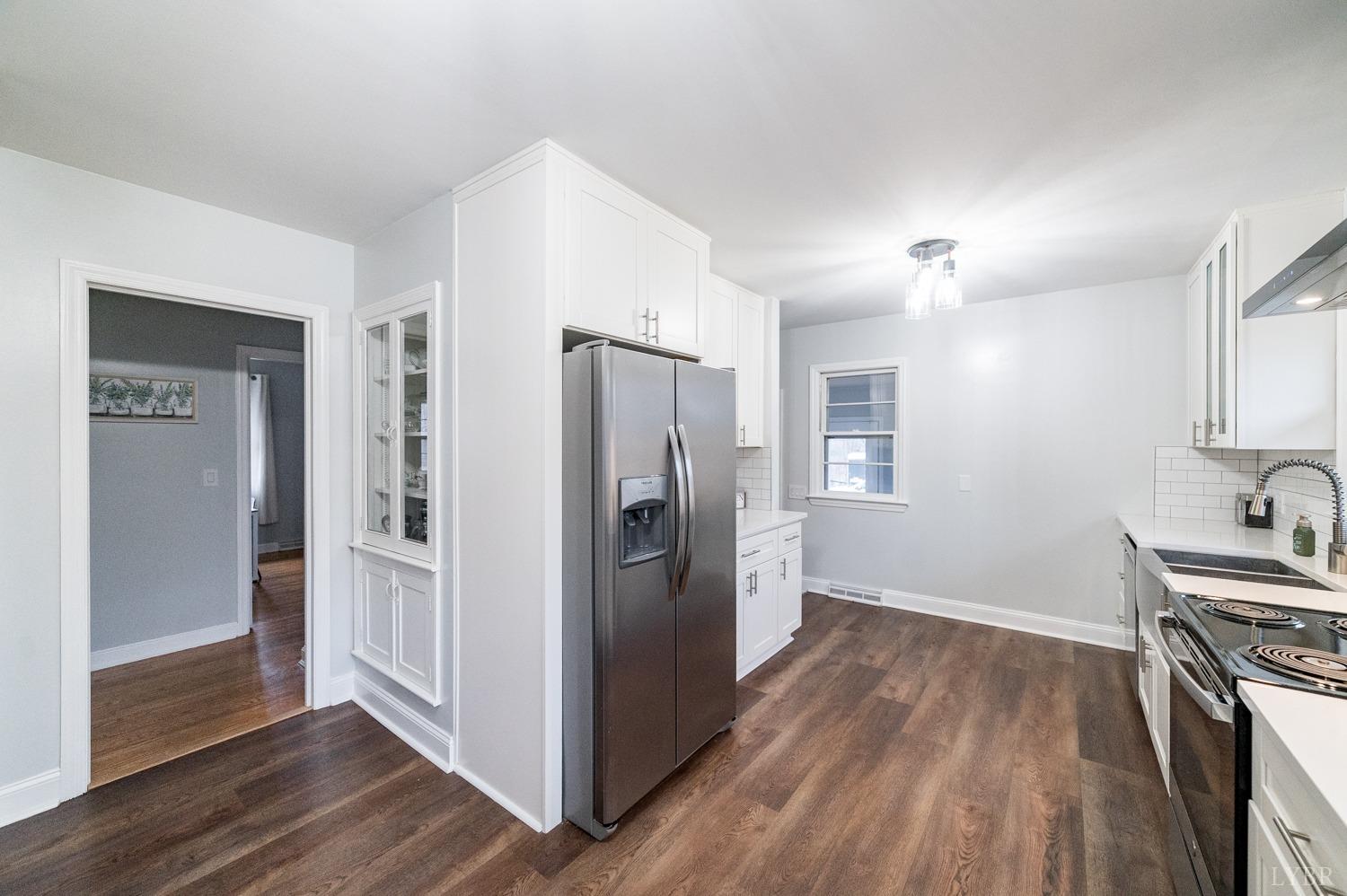 286 Flat Woods Road Amherst, VA 24521 - Photo 13 of 58 a view of a kitchen with a refrigerator a sink and dishwasher wooden floor