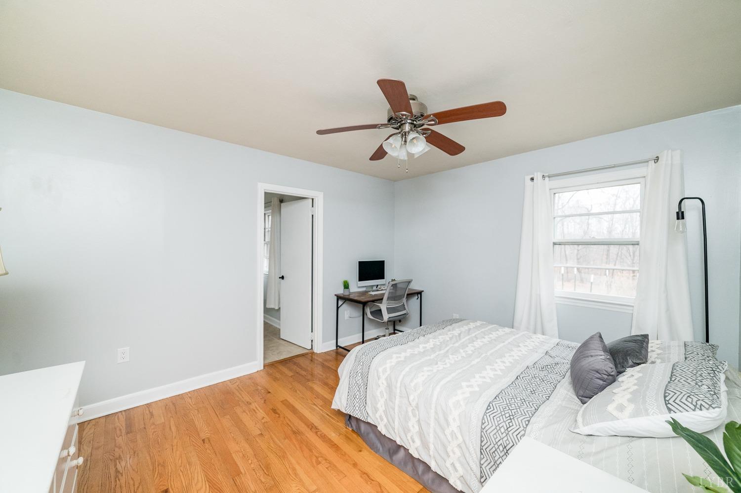 286 Flat Woods Road Amherst, VA 24521 - Photo 17 of 58 a bedroom with a large bed and a chandelier