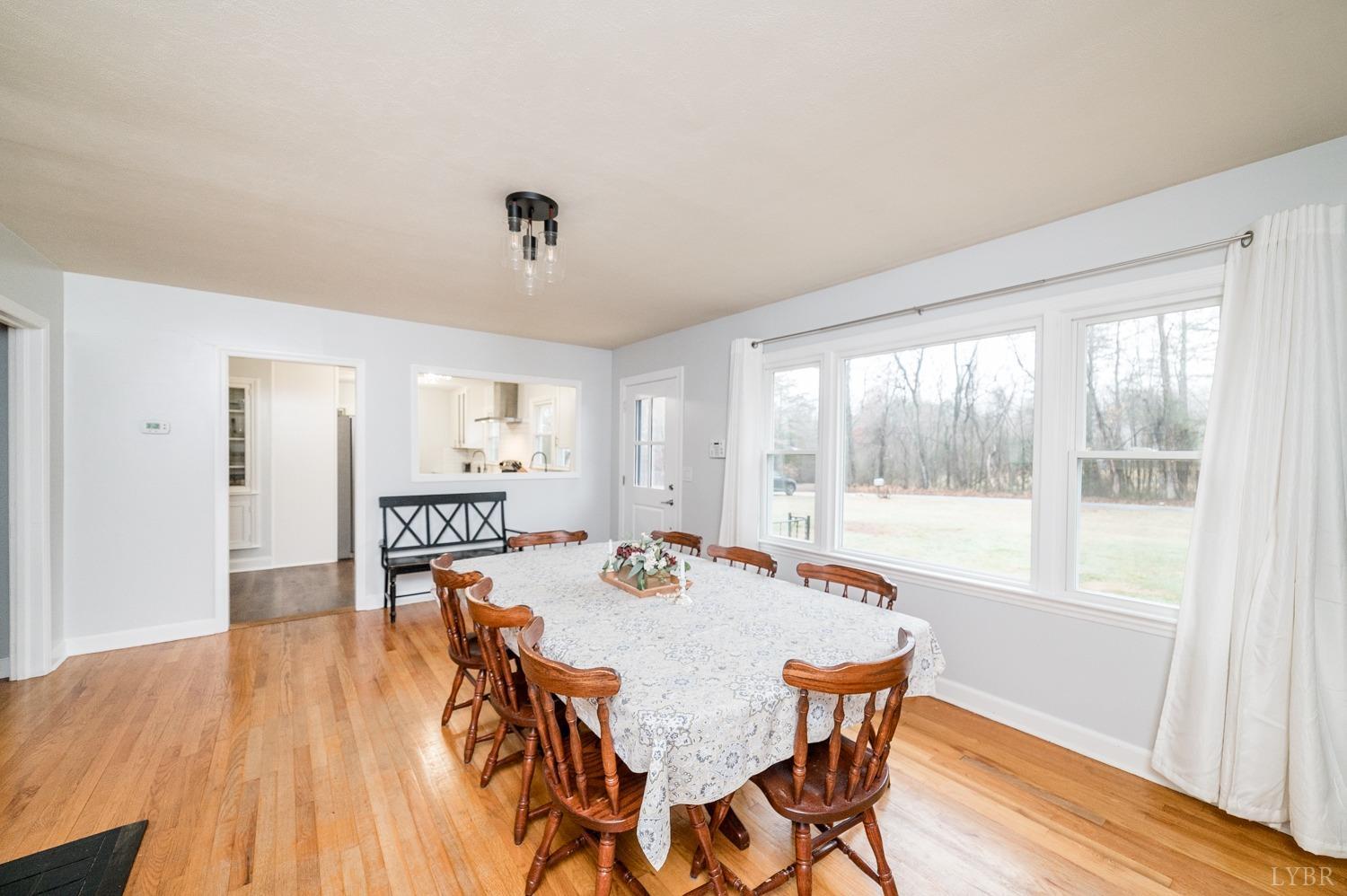 286 Flat Woods Road Amherst, VA 24521 - Photo 7 of 58 a view of a dining room with furniture window and wooden floor