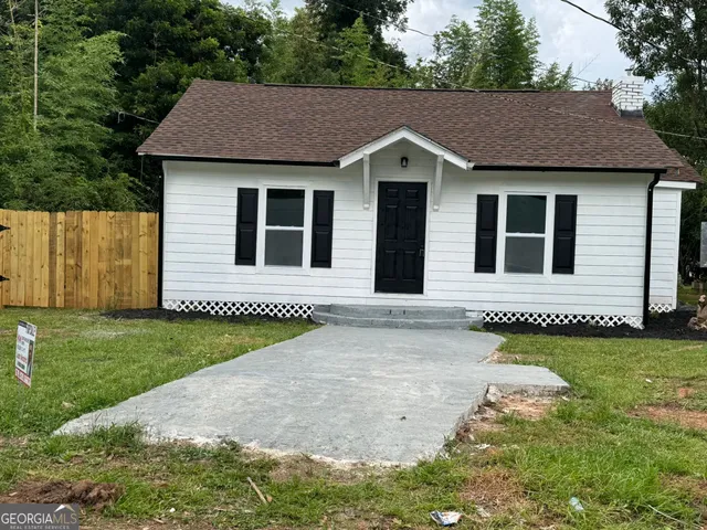 a view of a house with a garden and yard