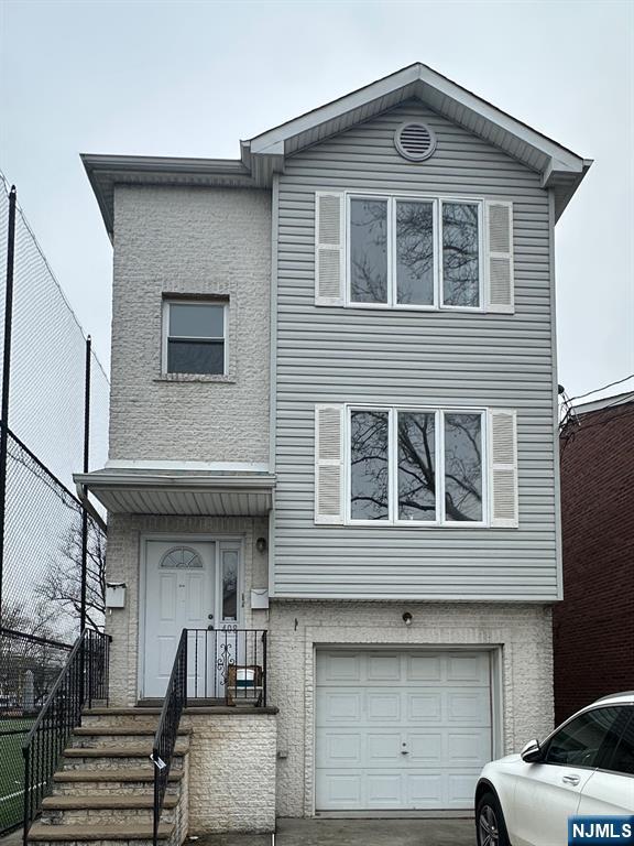 408 Jersey Street Harrison, NJ 07029 - Photo 1 of 10 a front view of a house with many windows