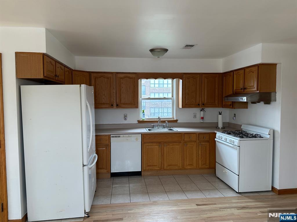 408 Jersey Street Harrison, NJ 07029 - Photo 3 of 10 a kitchen with stainless steel appliances granite countertop a refrigerator sink and stove