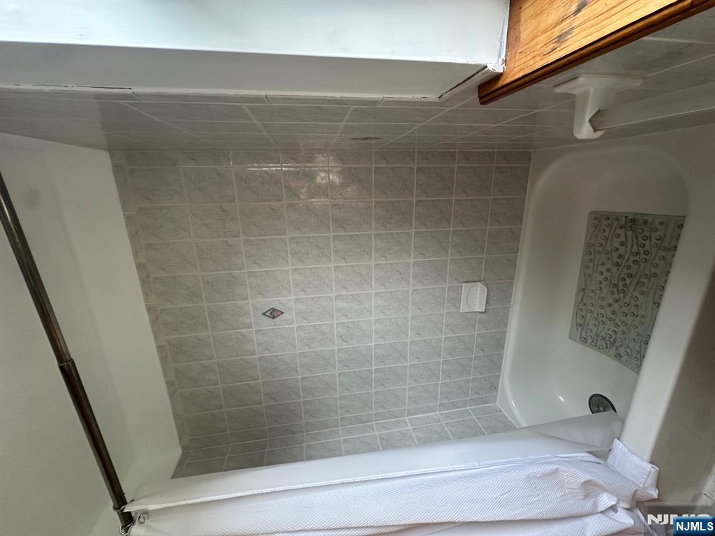 408 Jersey Street Harrison, NJ 07029 - Photo 4 of 10 a bathroom with a shower and a bath tub