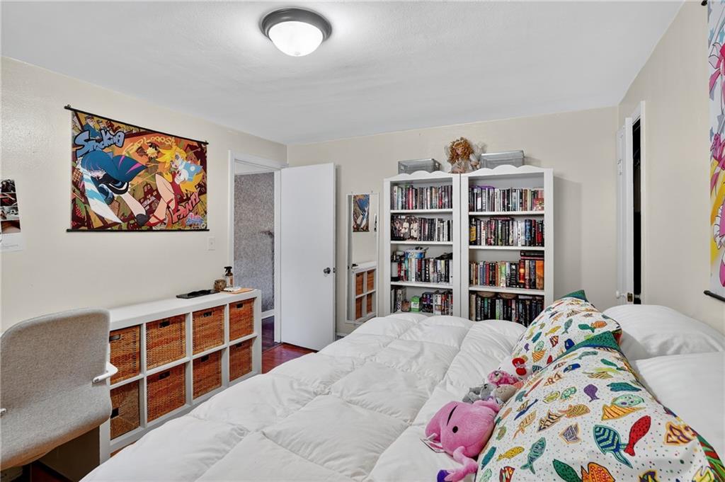 5765 Library Road Bethel Park, PA 15102 - Photo 16 of 34 a bedroom with a bed and a book shelf