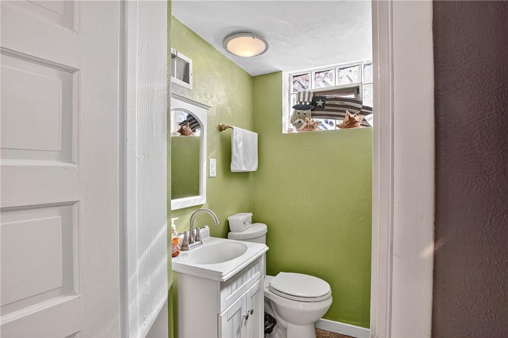 5765 Library Road Bethel Park, PA 15102 - Photo 18 of 34 a bathroom with a toilet sink and mirror