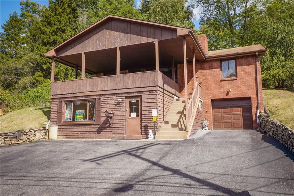 5765 Library Road Bethel Park, PA 15102 - Photo 2 of 34 a front view of a house with garage