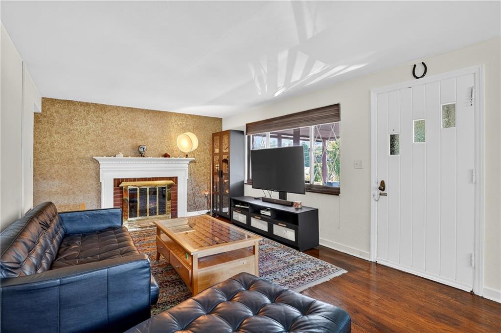 5765 Library Road Bethel Park, PA 15102 - Photo 4 of 34 a living room with furniture and a flat screen tv