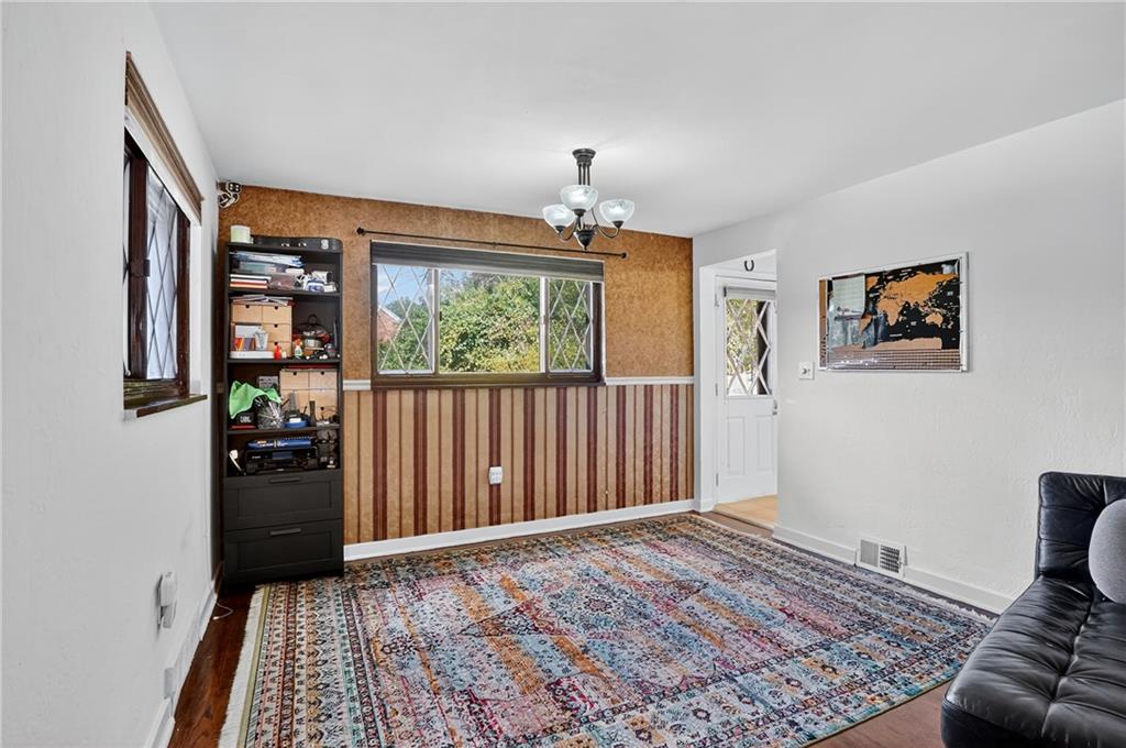 5765 Library Road Bethel Park, PA 15102 - Photo 6 of 34 a view of a livingroom with wooden floor and a window