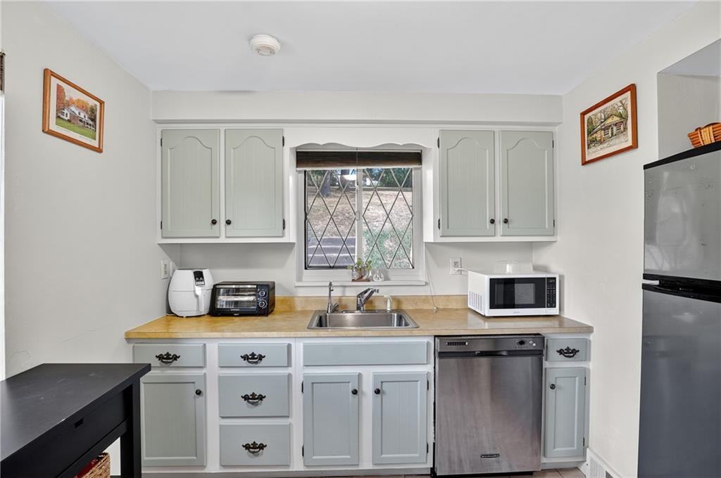 5765 Library Road Bethel Park, PA 15102 - Photo 8 of 34 a kitchen with a sink stove and microwave