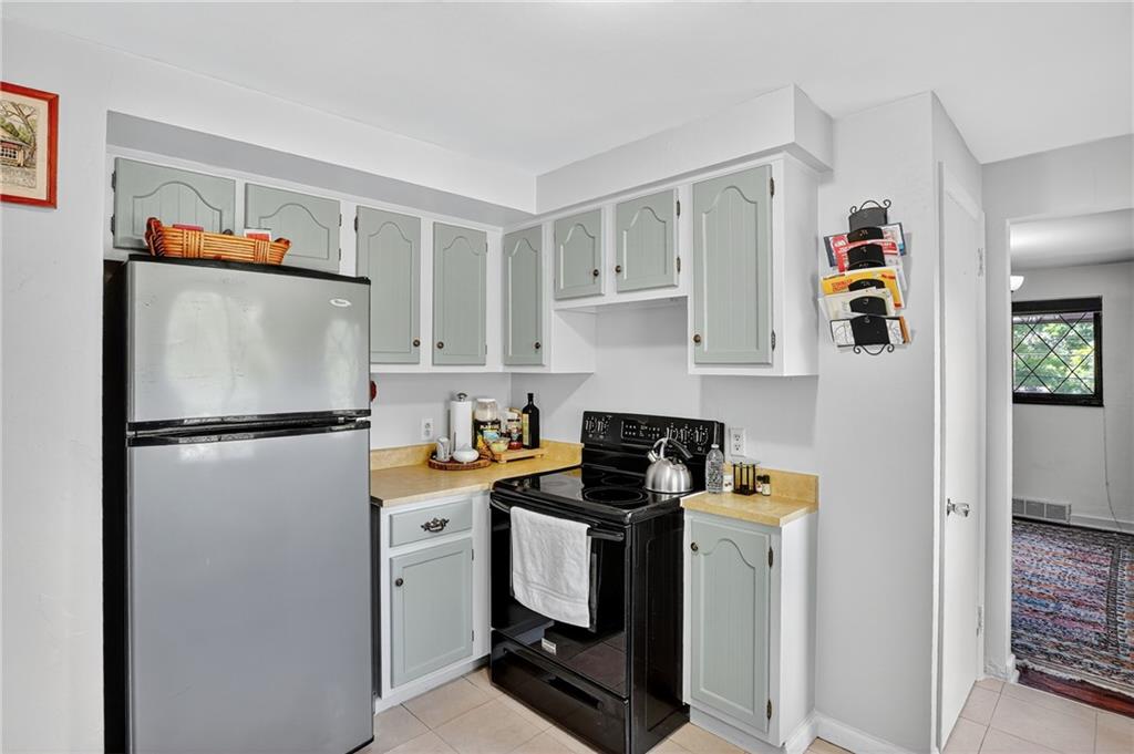 5765 Library Road Bethel Park, PA 15102 - Photo 10 of 34 a white refrigerator freezer sitting inside of a kitchen