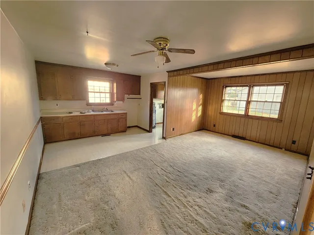 a view of empty room with a fireplace and windows