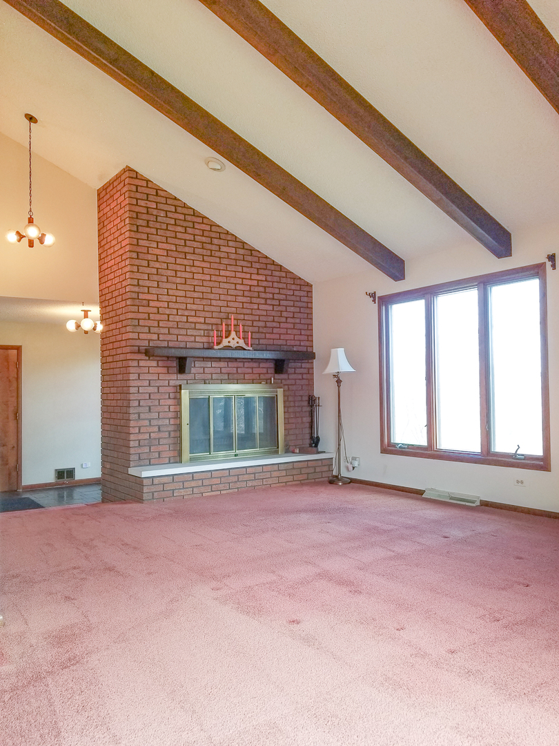 S030 Rowe Road Elburn, IL 60119 - Photo 22 of 35 a view of an empty room with a fireplace and a window
