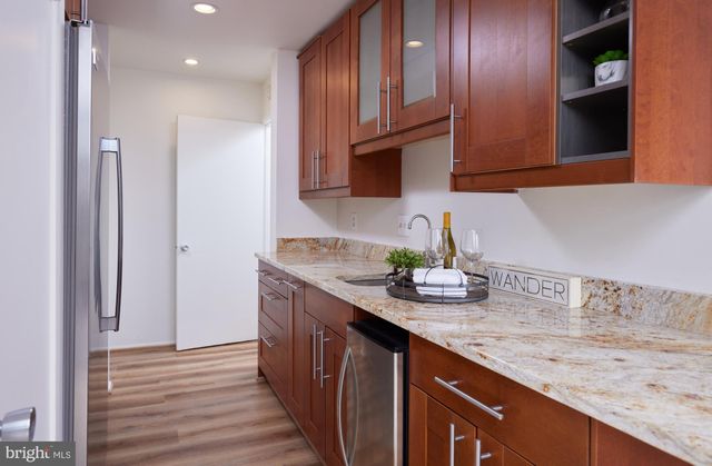 a kitchen with stainless steel appliances granite countertop a sink a stove and a refrigerator