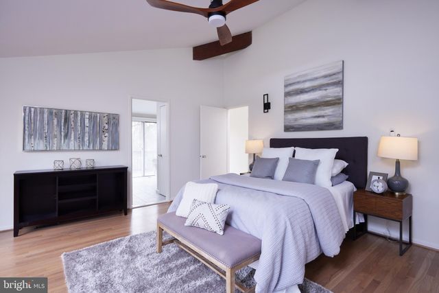 a bedroom with furniture and a wooden floor