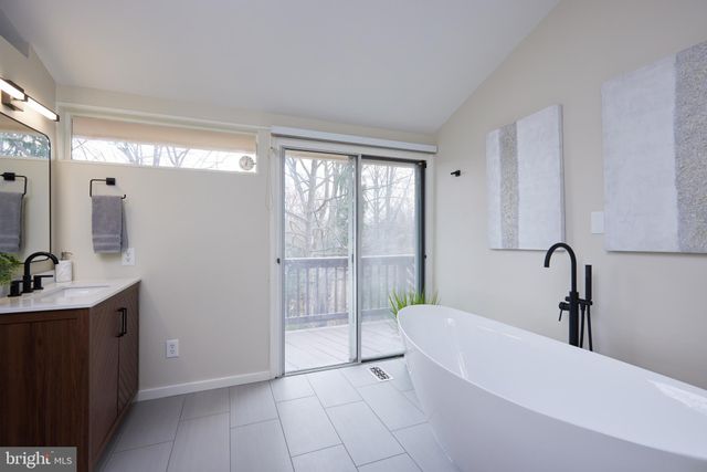 a bathroom with a double vanity sink mirror and toilet