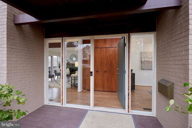 a view of a room with a table and chairs