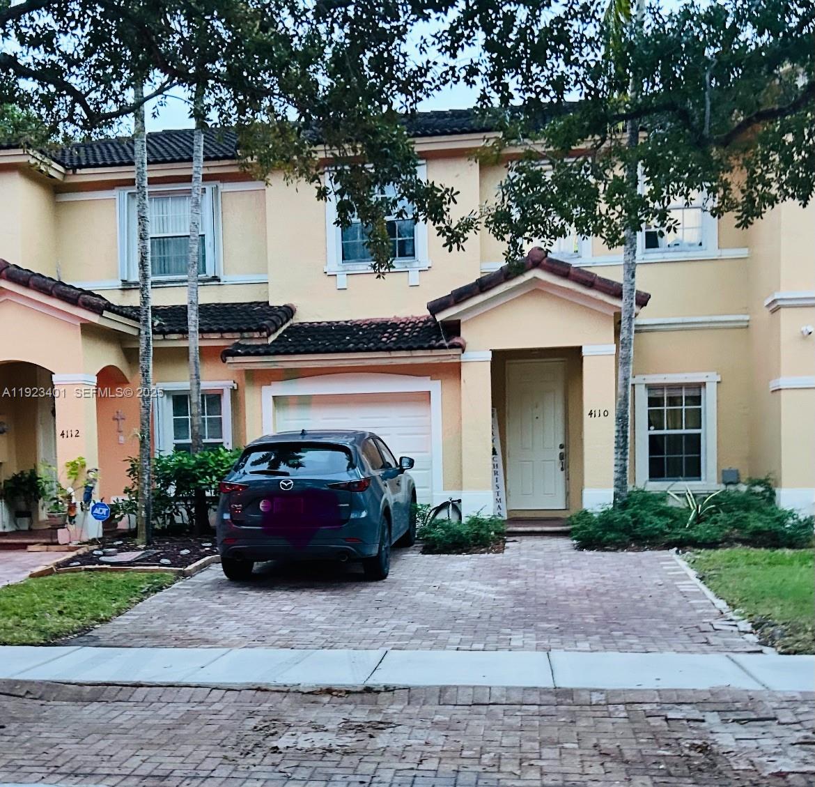 4110 Northeast 24th Street Homestead, FL 33033 - Photo 1 of 16 a front view of a house with garage