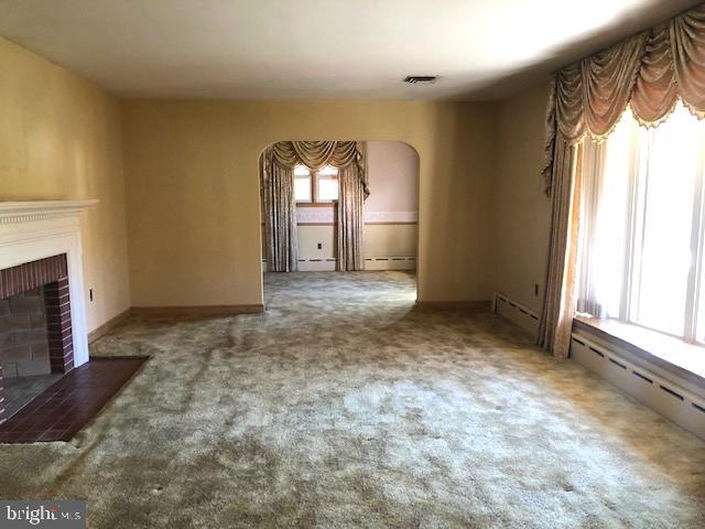 11801 Seven Locks Road Potomac, MD 20854 - Photo 2 of 10 living room with wood-burning fireplace.
