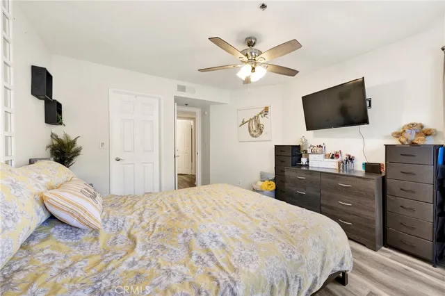 a bedroom with a bed and a flat screen tv