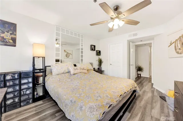 a large bedroom with bed and a chandelier