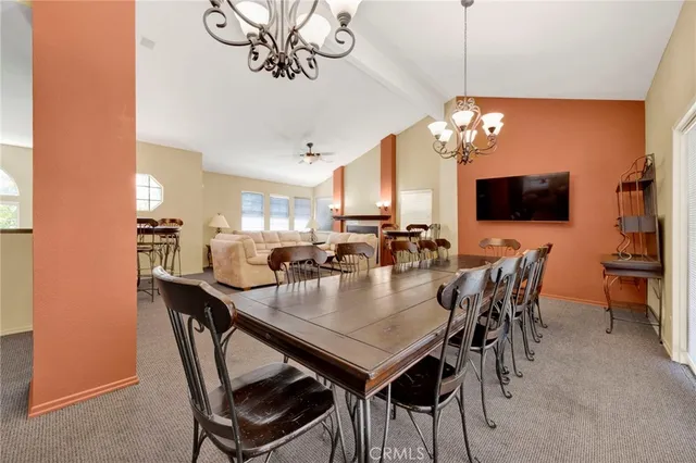 a view of a dining room with furniture a chandelier and wooden floor