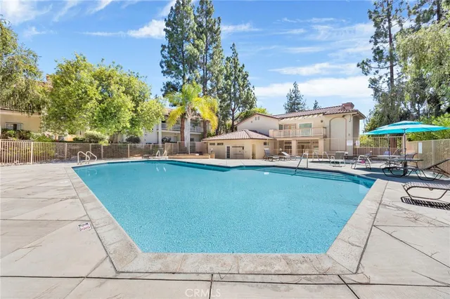 a backyard of a house with a garden and outdoor seating