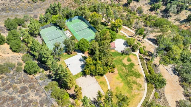 an aerial view of a houses with a street and green space