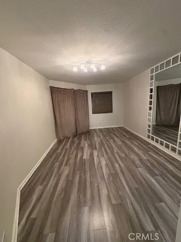 a view of storage and utility room with wooden floor